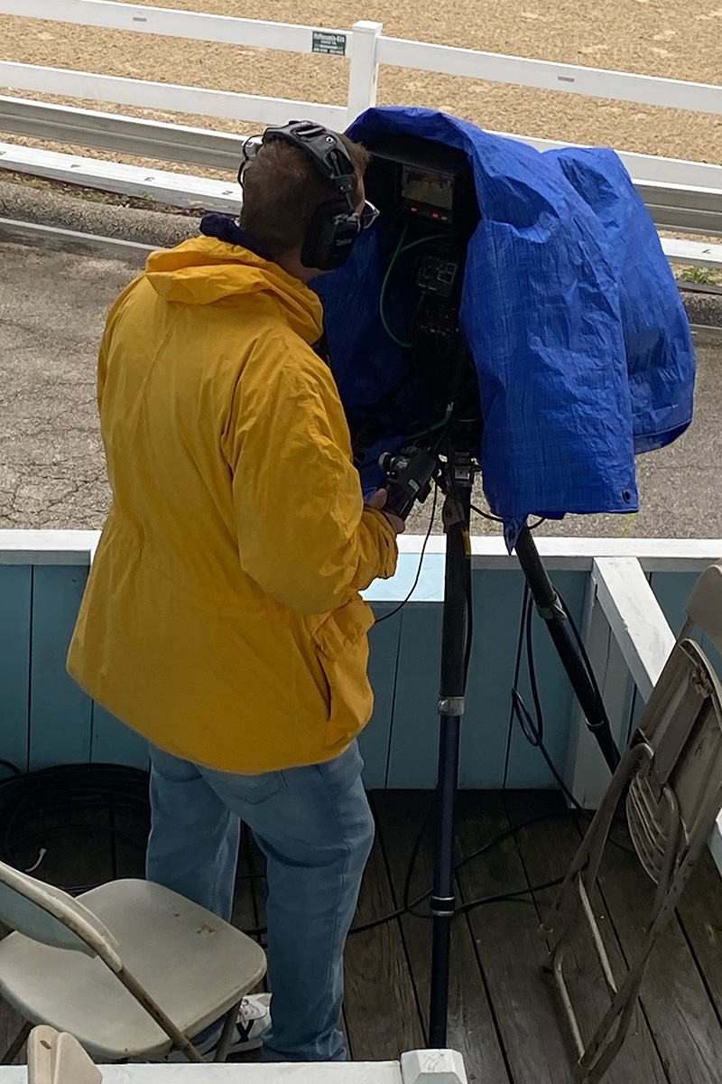 A camera being operated under all-weather gear
